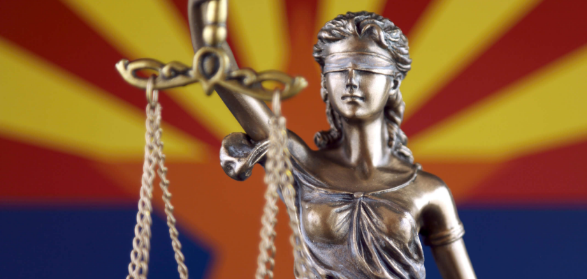 Lady Justice in front of Arizona flag